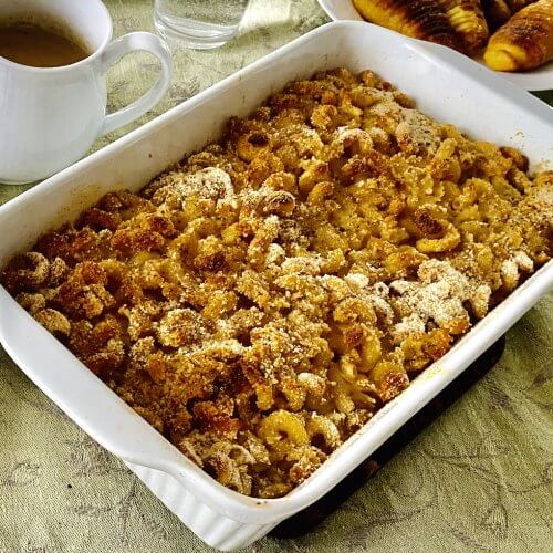 Baked Finnish macaroni casserole in a white ceramic dish with a golden, crispy top.