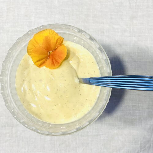 Homemade vanilla custard sauce in a white frosted Mariskooli bowl