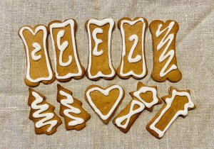 Rustic Finnish gingerbread cookies decorated with white royal icing, arranged on a linen napkin with a cozy, homemade feel.