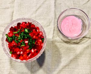 Mixed Finnish rosolli salad with diced beets, potatoes, carrots, apples, and pickles in a frosted bowl, served with creamy beet sauce on the side.