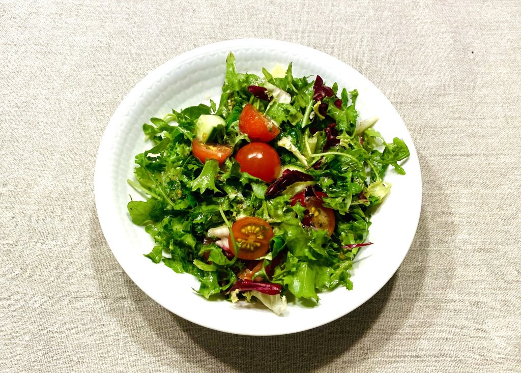 Mixed Lettuce Salad with Tomatoes and Cucumber Fresh salad made with mixed lettuce leaves, cherry tomatoes, and cucumber, dressed lightly with vinaigrette.