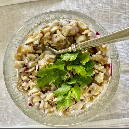 Creamy Finnish wild mushroom salad garnished with fresh parsley.