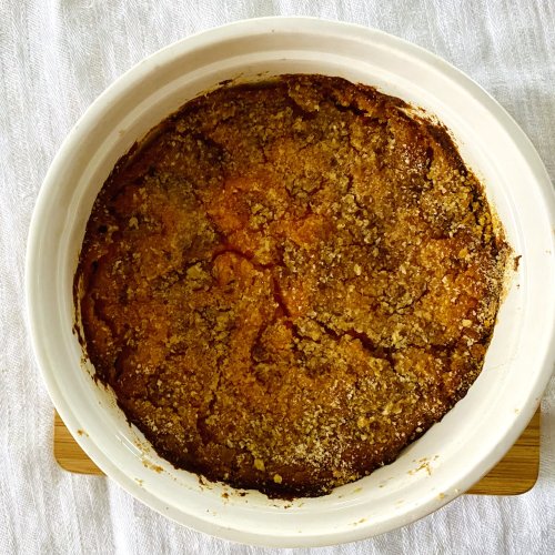 Finnish Christmas carrot casserole baked in a white ceramic dish with a golden surface.