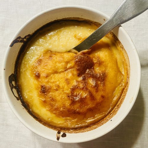 Traditional Finnish sweetened potato casserole baked until golden brown in a ceramic dish.