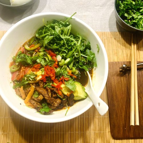 Easy pork ramen soup bowl with miso broth, noodles, marinated pork loin, soft-boiled egg, vegetables, and avocado.