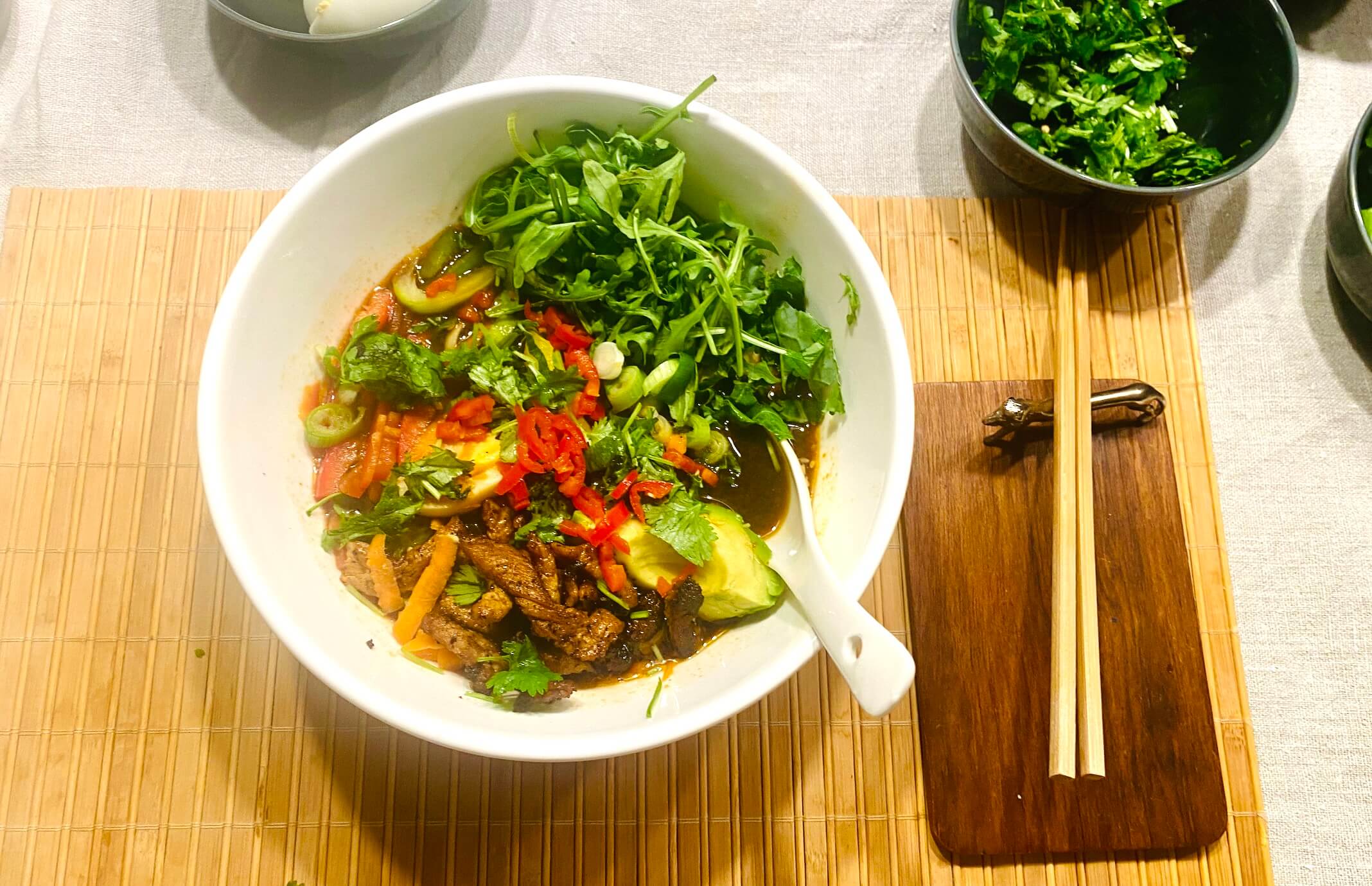 Easy pork ramen soup bowl with miso broth, noodles, marinated pork loin, soft-boiled egg, vegetables, and avocado.