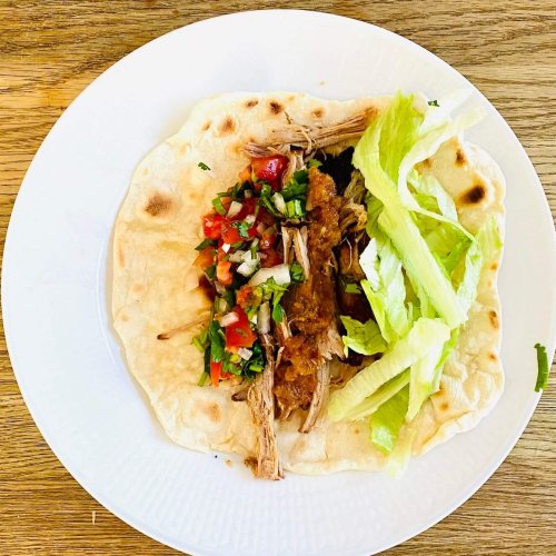Pulled pork tortillas filled with tender shredded pork, crisp lettuce, pico de gallo, and smooth roasted tomato salsa