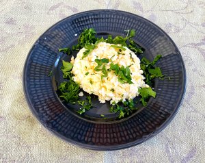 Finnish egg butter (munavoi) shaped on a plate, garnished with chopped parsley