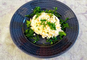 Finnish egg butter (munavoi) shaped on a plate, garnished with chopped parsley