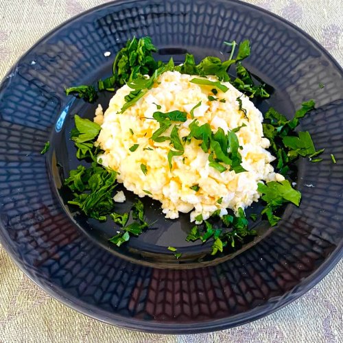 Finnish egg butter (munavoi) shaped on a plate, garnished with chopped parsley