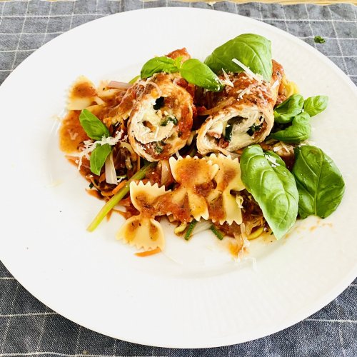 Stuffed pork rolls with mozzarella, basil and sun-dried tomatoes served with farfalle pasta and tomato sauce