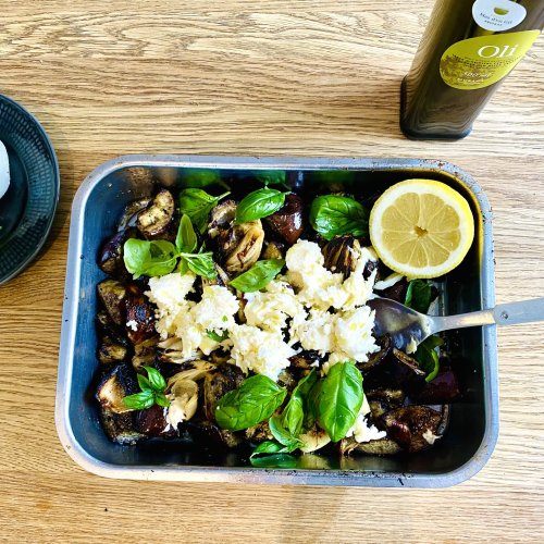 Grilled eggplant with mozzarella, basil, onions, and garlic in a grilling dish