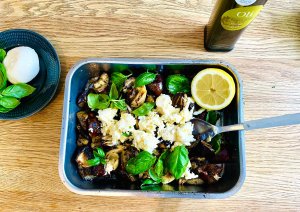 Grilled eggplant with mozzarella, basil, onions, and garlic in a grilling dish