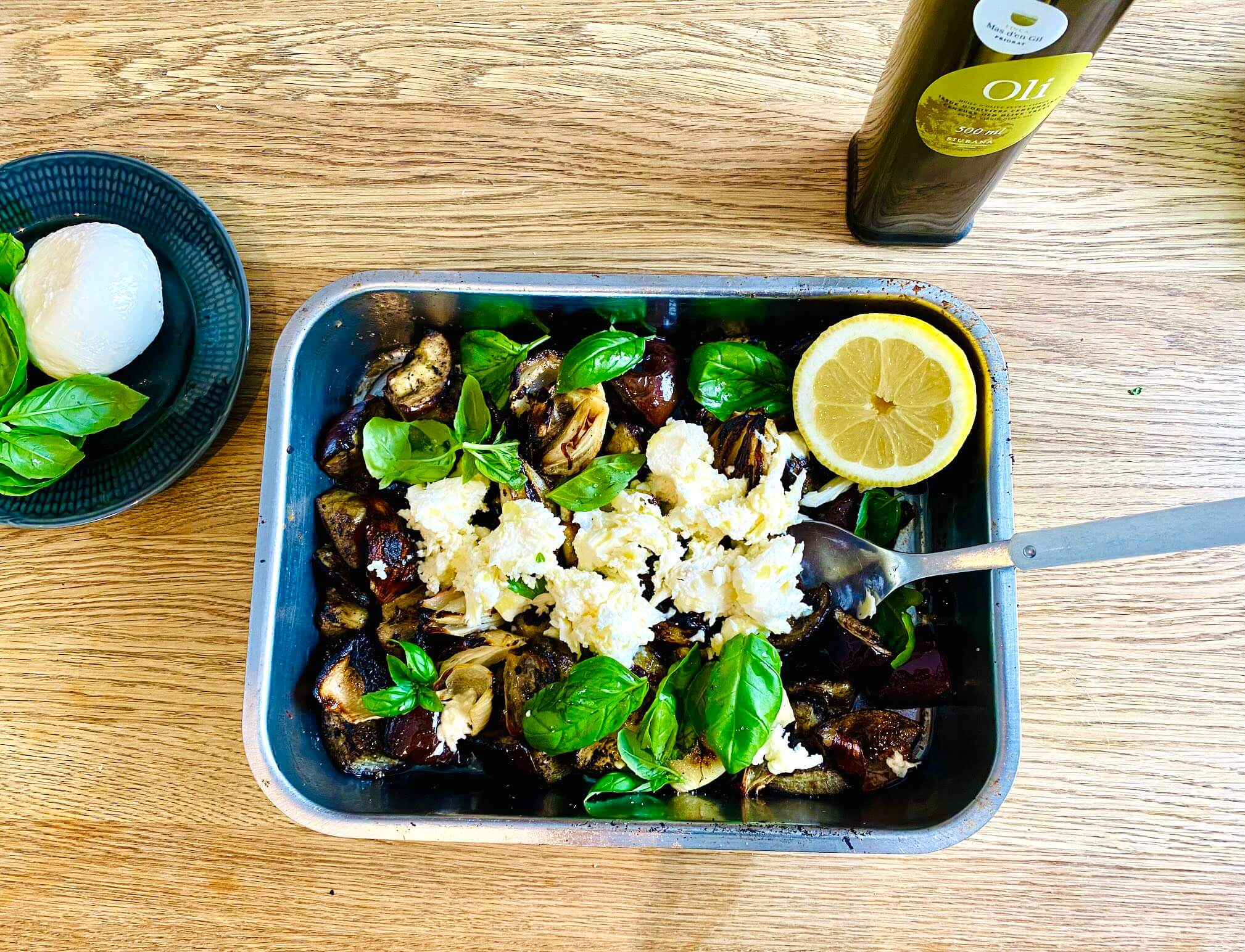Grilled eggplant with mozzarella, basil, onions, and garlic in a grilling dish