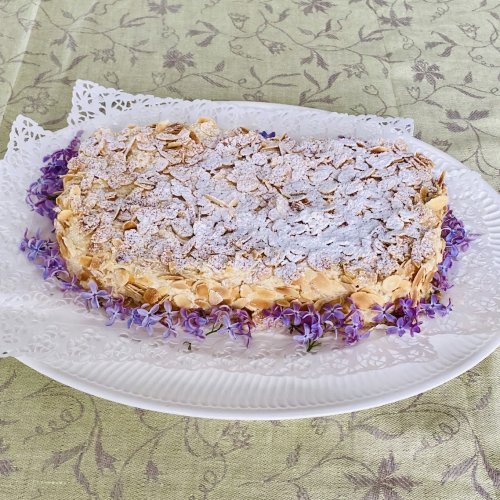Finnish Ellen Svinhufvud cake decorated with toasted almonds and lilac blossoms