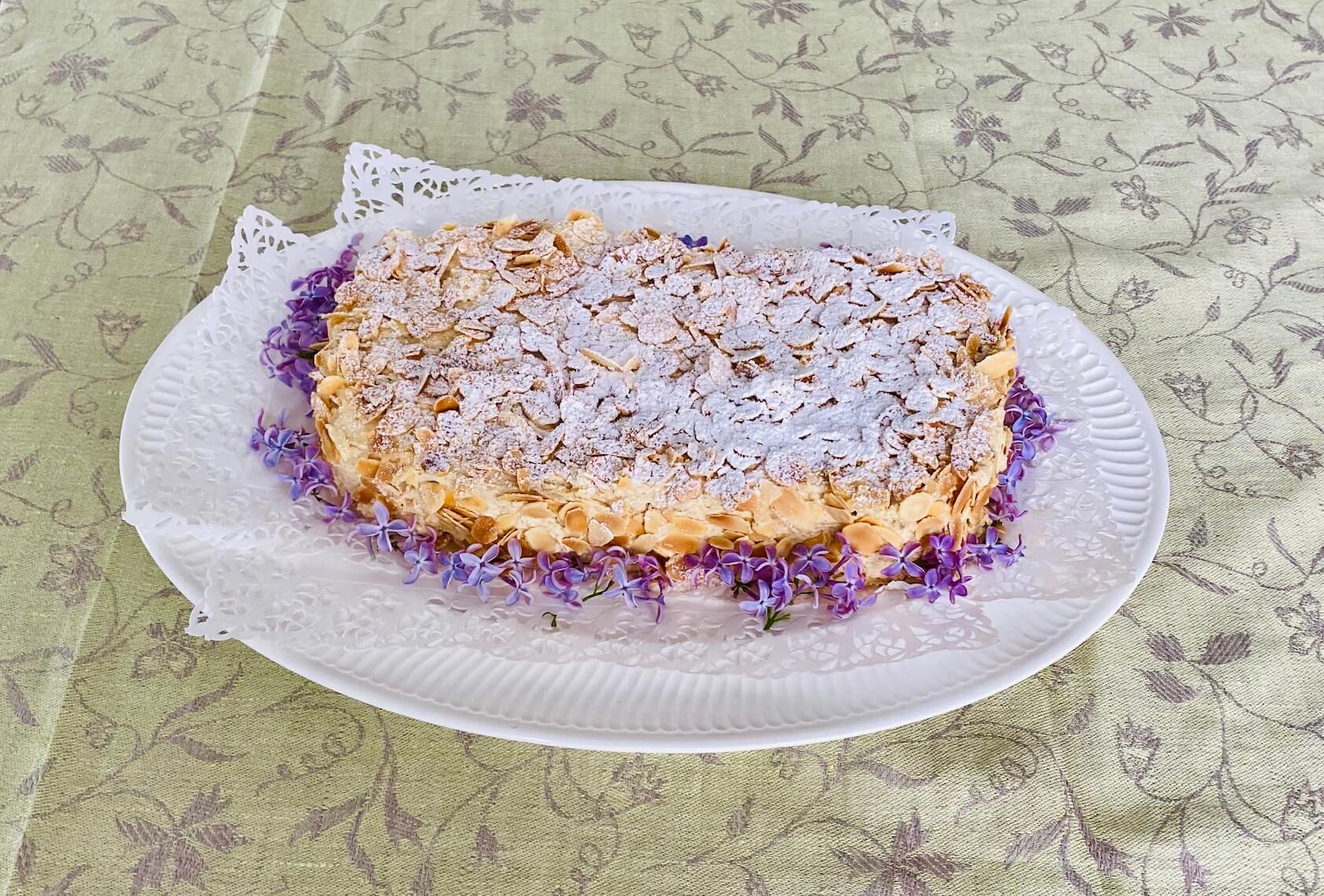 Finnish Ellen Svinhufvud cake decorated with toasted almonds and lilac blossoms