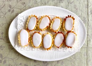 Mazarin tartlets arranged on an oval white serving plate