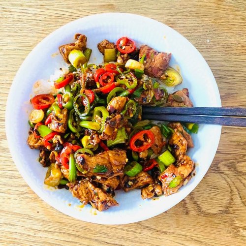Sichuan chili pork served with steamed jasmine rice and chopsticks