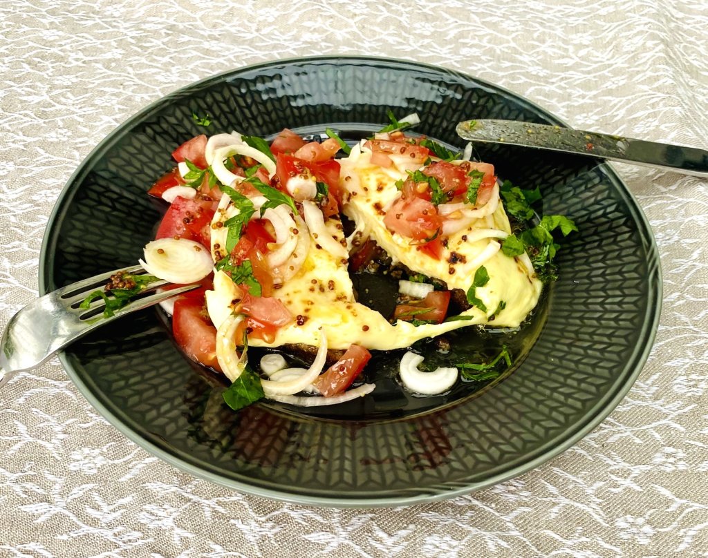 Split Finnish bread cheese toast with melted leipäjuusto and fresh tomato salad
