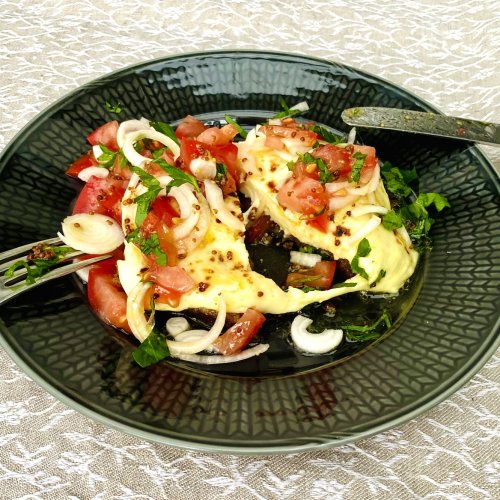 Split Finnish bread cheese toast with melted leipäjuusto and fresh tomato salad