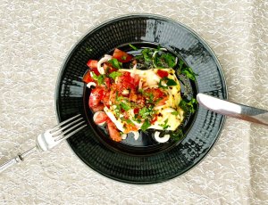 Finnish bread cheese toast with tomato salad served on a plate