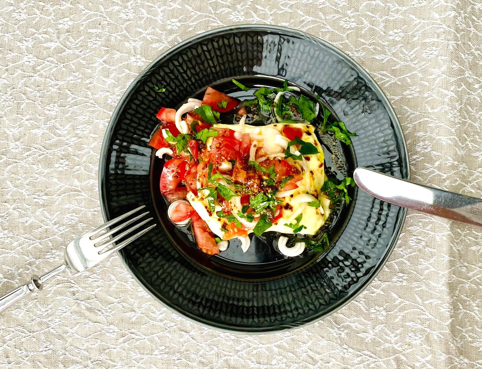 Finnish bread cheese toast with tomato salad served on a plate