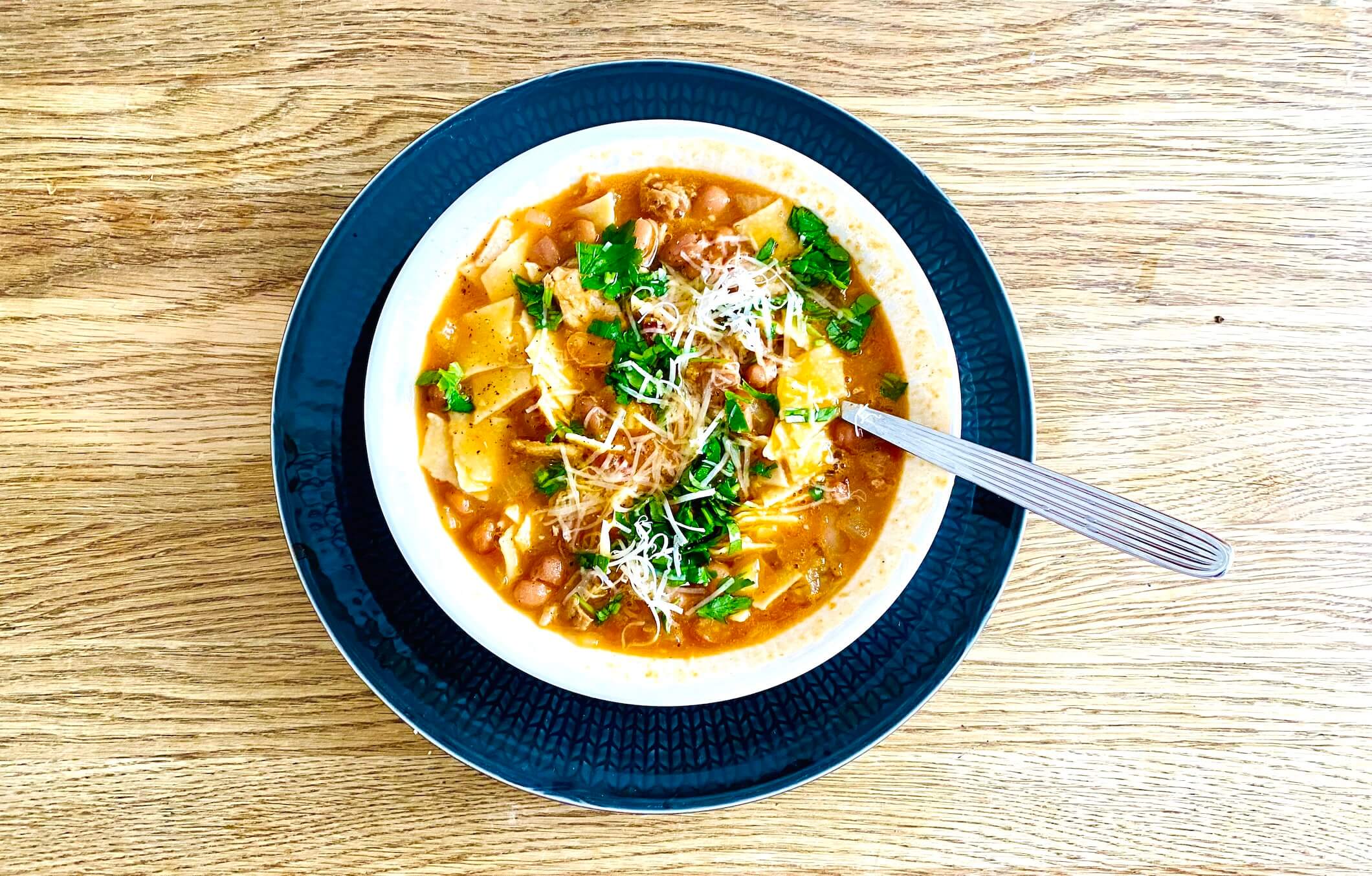 Pasta and bean stew with borlotti beans, tomatoes, pancetta, parsley, and Parmesan